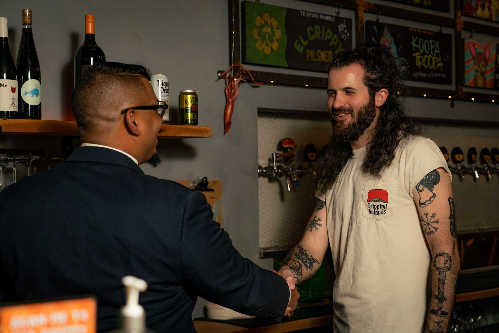Shaking hands with brewery owner.